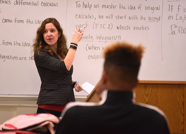 Female professor at a white board